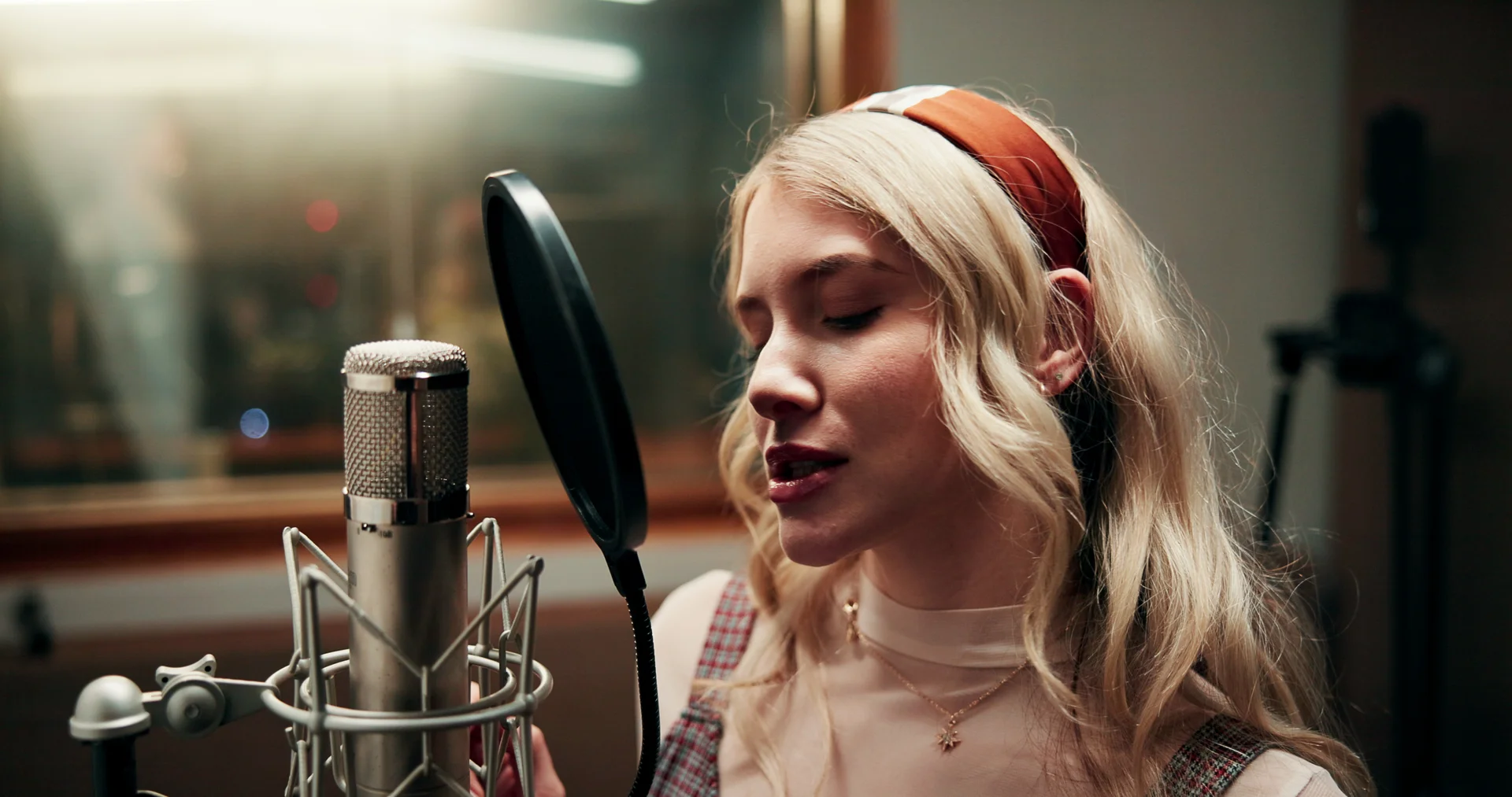 A voice artist recording in a professional studio